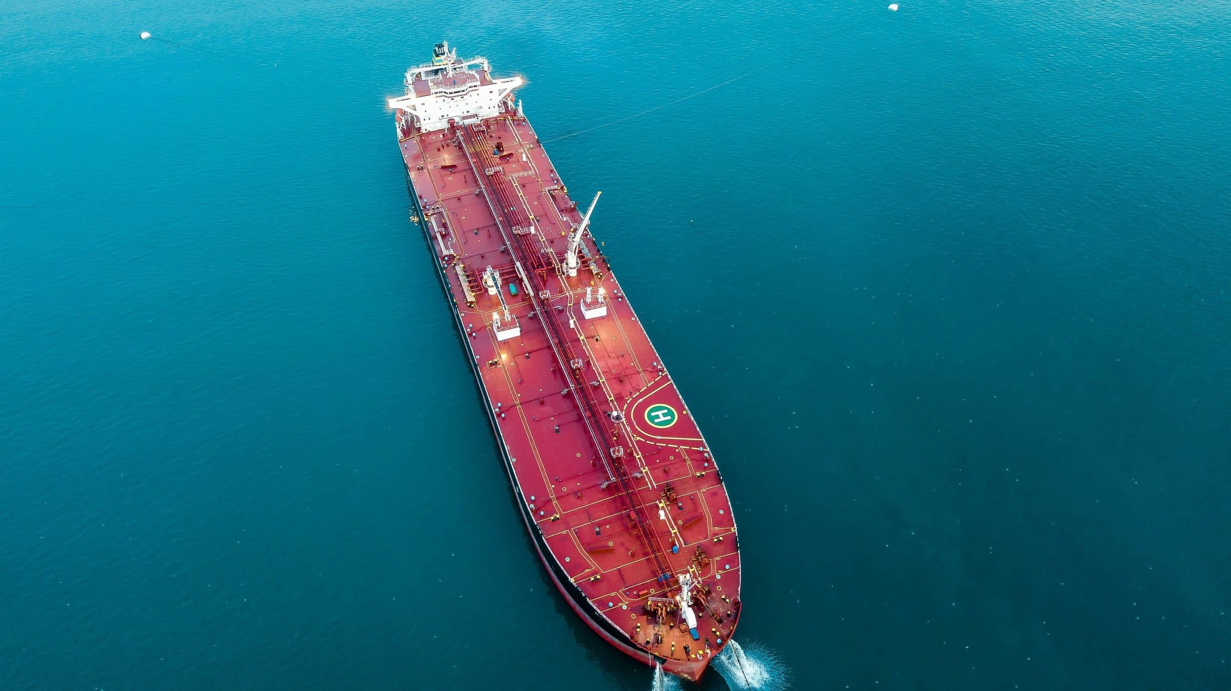 Aerial view of a crude oil tanker underway on teal water