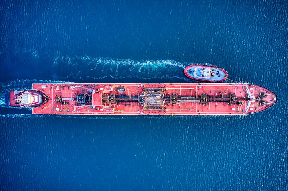Aerial view of a laden product tanker escorted by a pilot boat